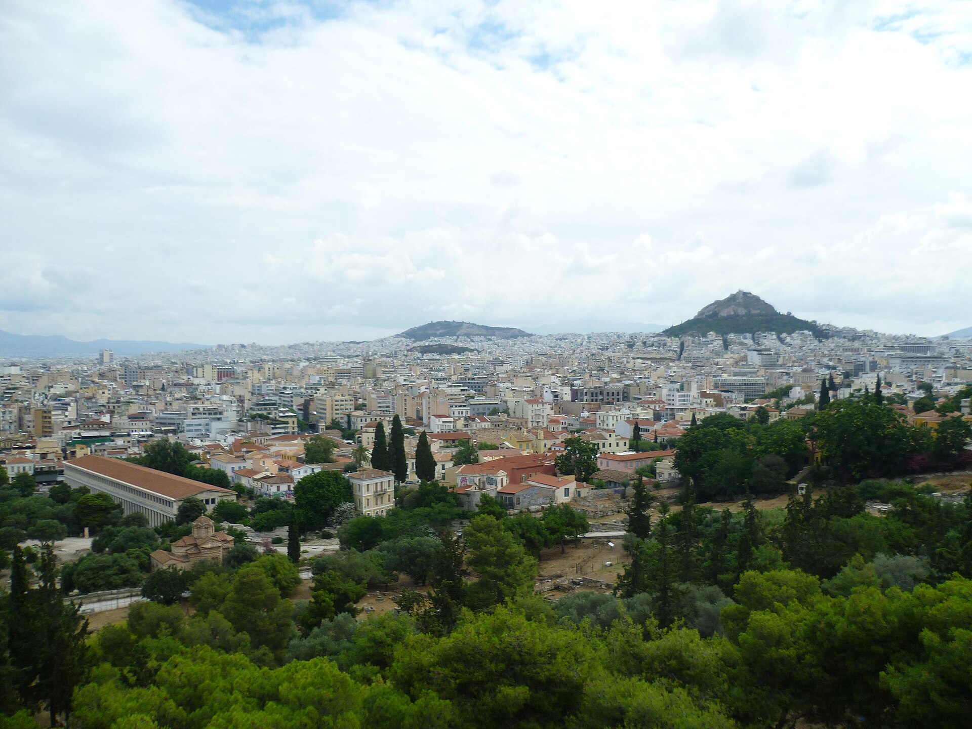 Athens rooftops with Lycabettus Hill rising beyond